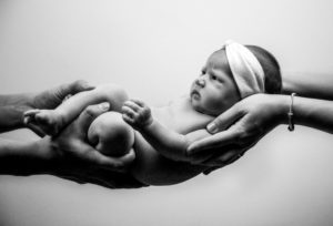 baby-held-by-parents-hands